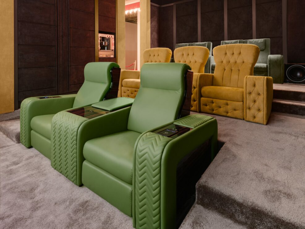 Reclining cinema seating in green leather displayed at Salone del Mobile Milano